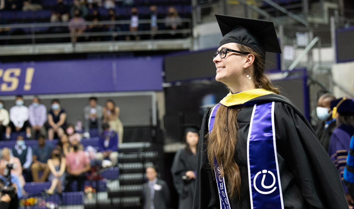 A student walks at Convocation.